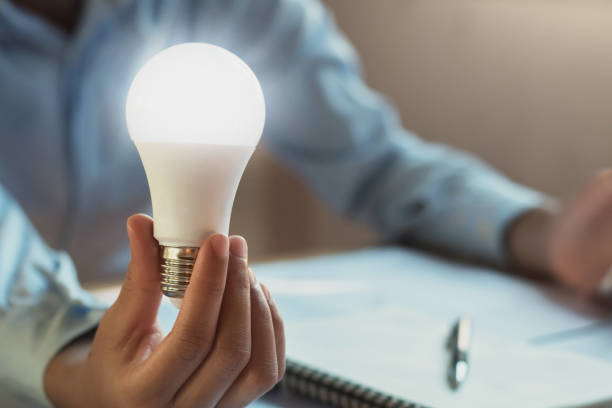 concept saving power energy. hand show led bulb