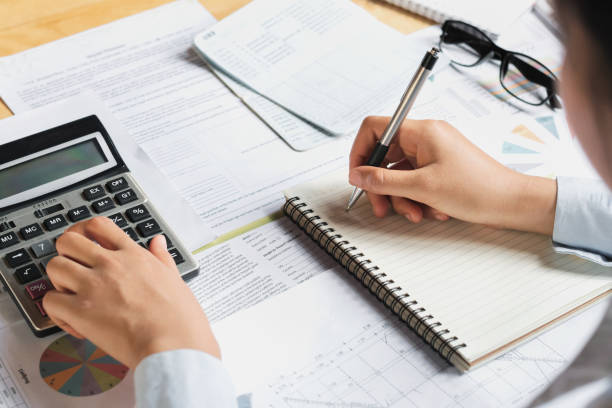 istock accountant using calculator for calculate budget finance on table in office 909461146