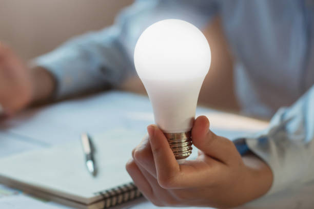 istock businessman holding show led bulb. concept saving power energy 909462184