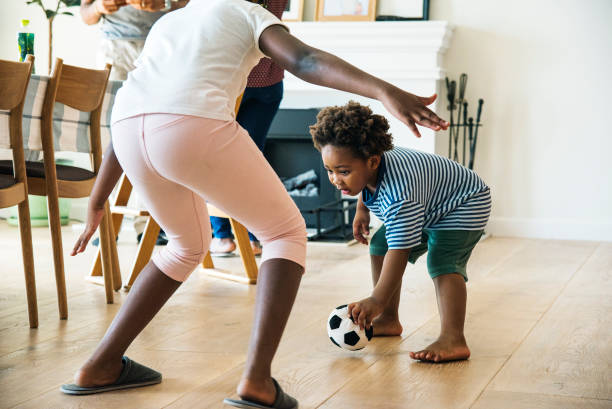 istock Kids playing ball indoors together 909462958