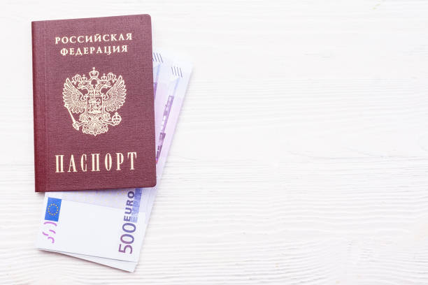 istock Russian passport with money 909463016