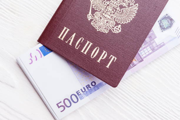 istock Russian passport with money 909463020