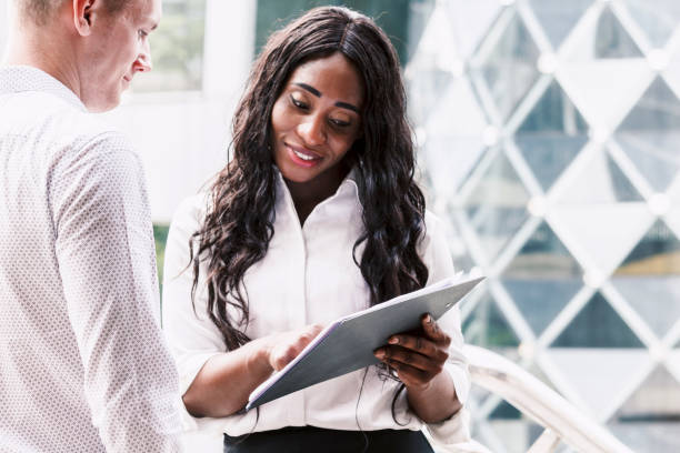 istock Image two business partners talking and working together 909463422