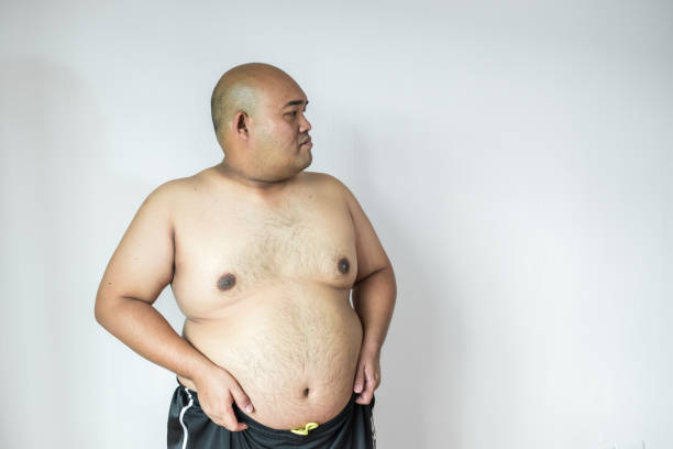 istock Fat man ,overweight man with big belly on white background in studio. 909467638