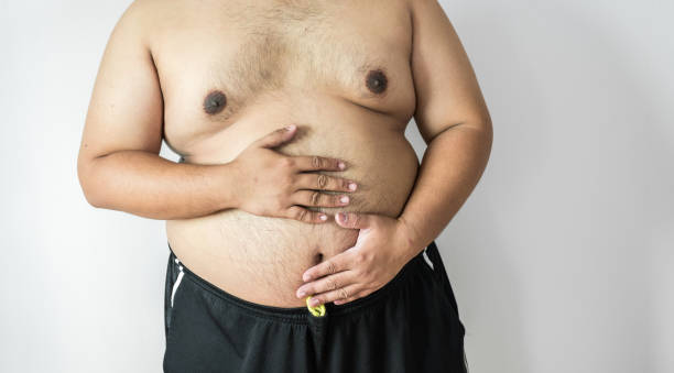 istock Fat man ,overweight man with big belly on white background in studio. 909467922