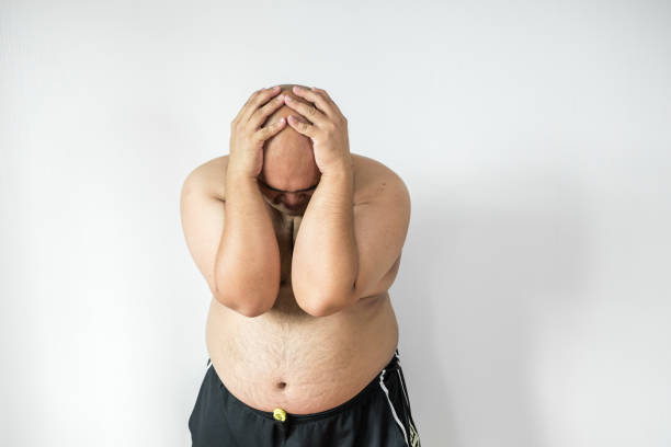 istock Fat man ,overweight man with big belly on white background in studio. 909467926