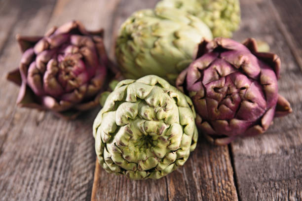 istock artichoke on wood background 909468610