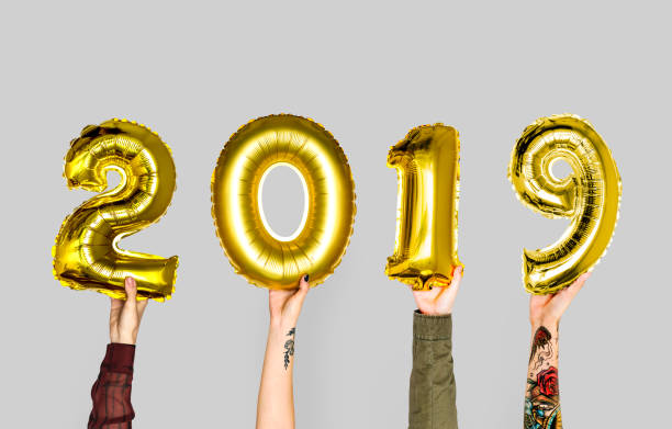 istock Hand holding new year 2019 balloon 909469566