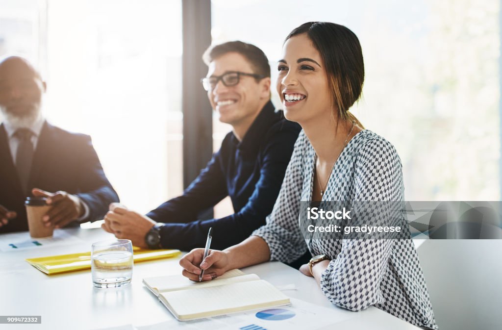 Success can only hatch through a committed team Shot of a group of businesspeople having a meeting in an office Happiness Stock Photo