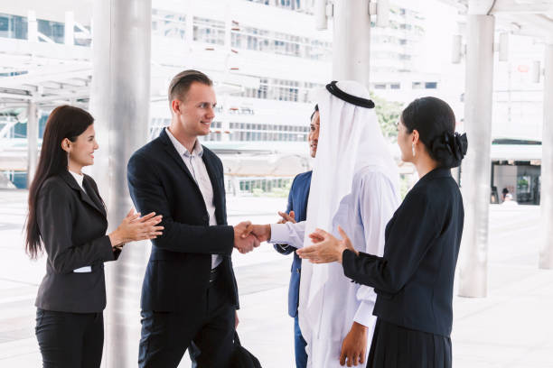 istock Successful businessmen handshake partner with arab businessman 909475414