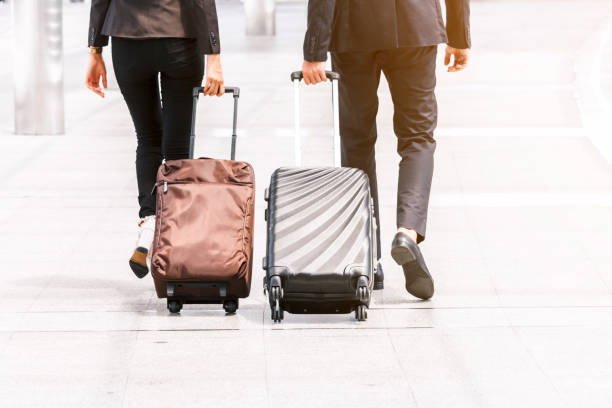 istock Business people walking with luggage 909475440
