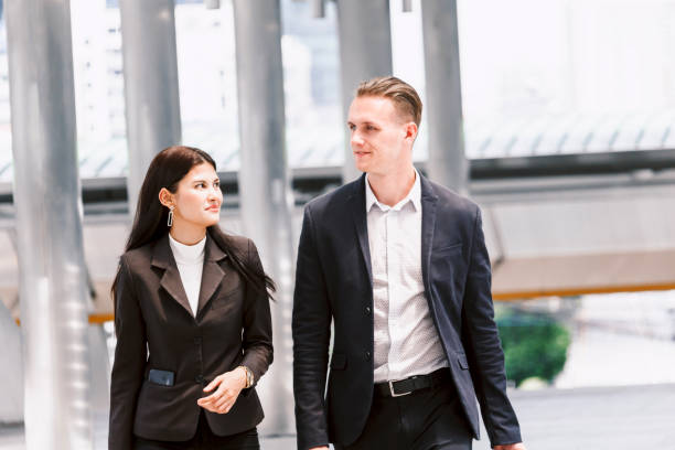 istock Image two business partners talking and working together 909475444