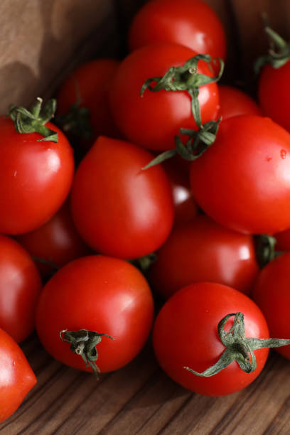 istock Fresh bright and juicy tomatoes on the kitchen 909479936