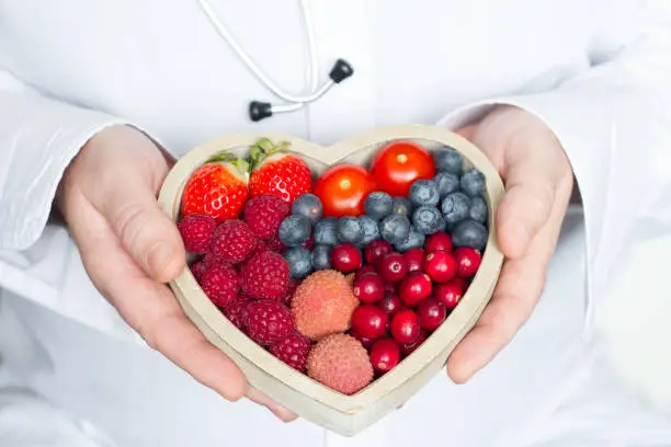 Photo of Doctor and stethoscope with heart healthy diet food abstract medicine concept