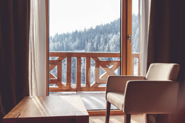 istock Living room with view on snow covered mountain. 909487982