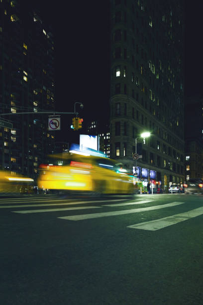 istock Manhattan motion blurred taxi at flatiron building 909488502