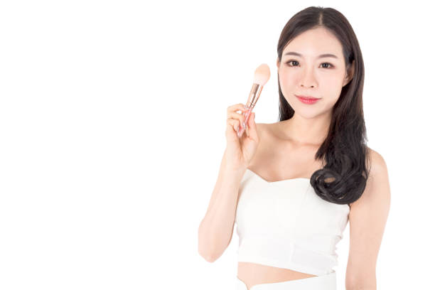 istock Woman holding make-up brushes isolated on white background 909488746