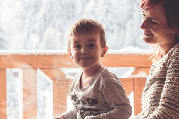 istock Mother and her son sitting in a comfortable chair 909493224