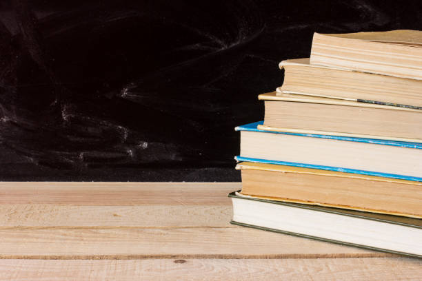 istock Old books on wooden desk. 909498772