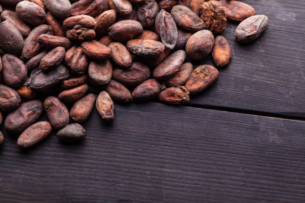 istock Raw cocoa beans on dark wood 909499346