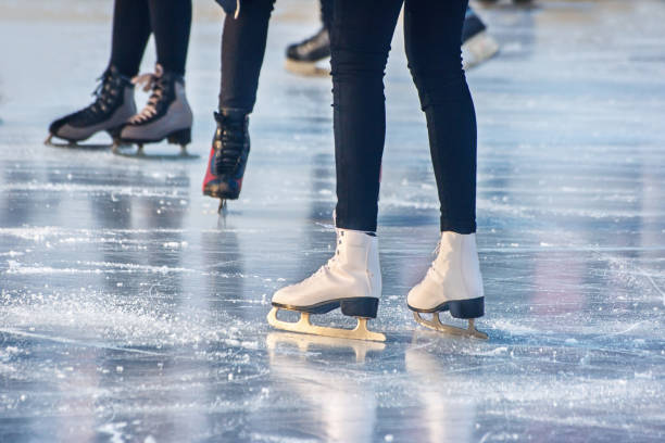 legs of people skating closeup legs of boys and girls skating on winter day closeup ice skating stock pictures, royalty-free photos & images