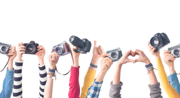 Different color hands holding  cameras Different color hands holding  cameras isolated color photos stock pictures, royalty-free photos & images