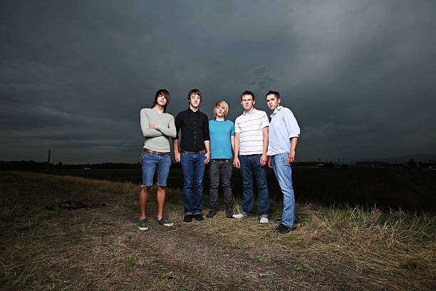 istock Group of Guys Standing Under Dark Sky 90950331
