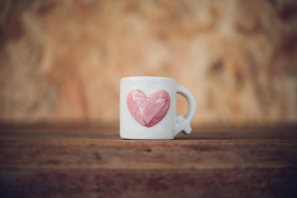 istock Cup heart shape on wooden floor in Valentine's Day 909509980