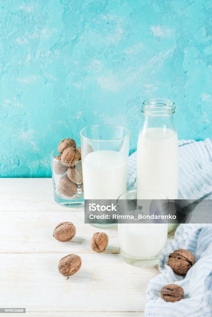 Vegan alternative non-dairy milk Vegan alternative food, walnut non-dairy milk on light blue background, copy space Alternative Lifestyle Stock Photo