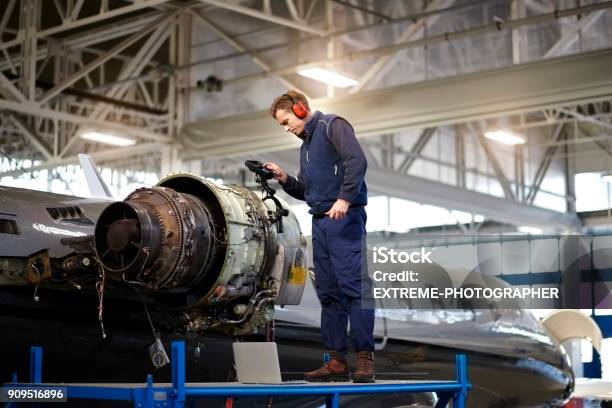 Aircraft Mechanic In The Hangar Stock Photo - Download Image Now - Aerospace Industry, Air Vehicle, Airplane Mechanic