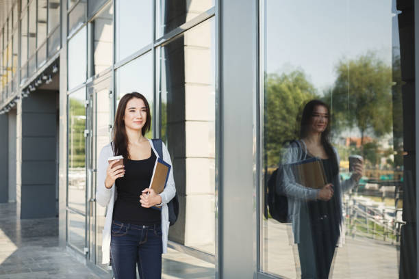 istock Beautiful student girl with textbooks and coffee 909519182