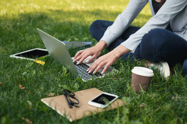 istock Young pensive woman using laptop in park 909519308