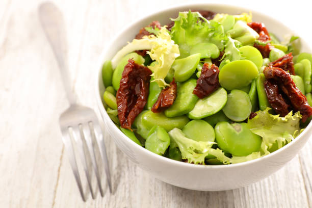 istock broad bean salad on wood background 909519504