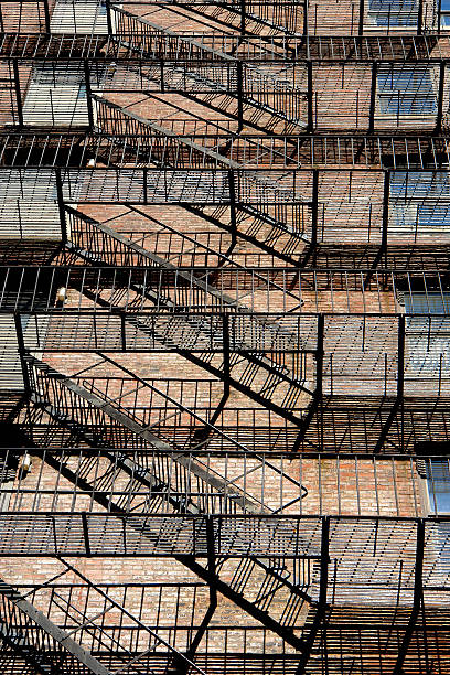 istock zig zagging fire escape on back of old apartment building 90952031