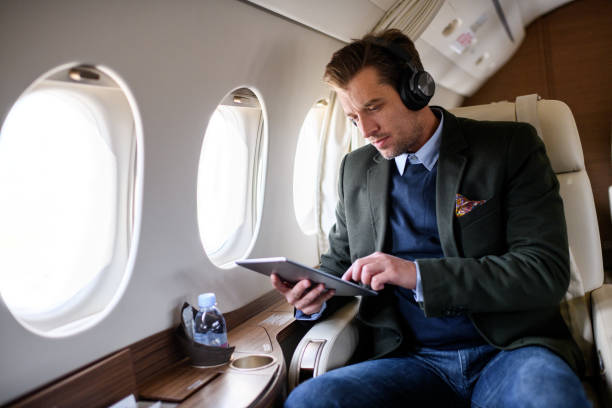 istock Man in private jet airplane 909521746