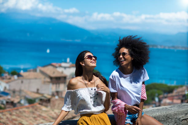 Two happy woman friends laughing