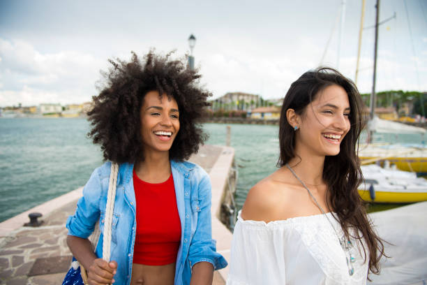 istock Two happy woman friends laughing 909522108