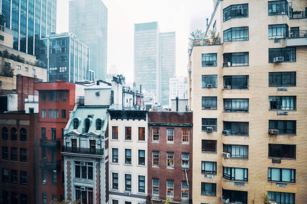 Vintage toned picture of old apartment buildings in Midtown Manhattan on a rainy day, New York, USA.