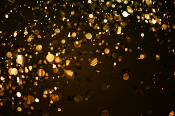 istock christmas gold sparkle glitter explosion dust particles background with bokeh, gold holiday happy new year and valentine day 909522964