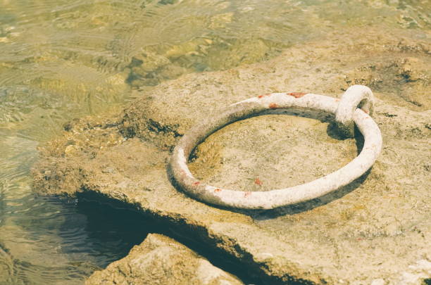 Rope tied to a mooring rusty ring