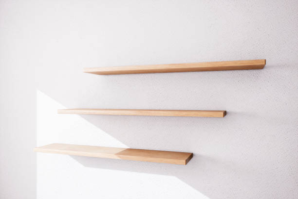 istock Three wooden shelves on a white plastered wall. 3d rendering. 909526168