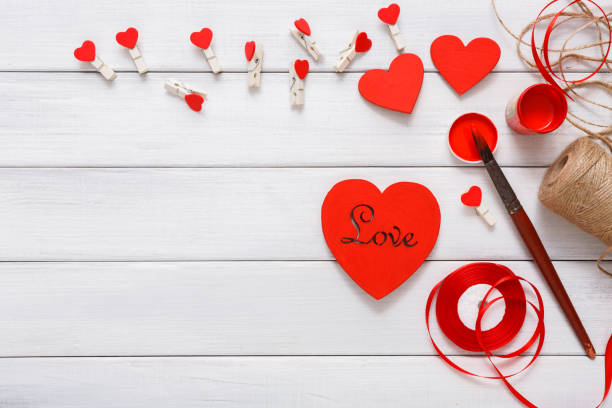istock Valentine day diy handmade hearts making, top view on wood 909526542