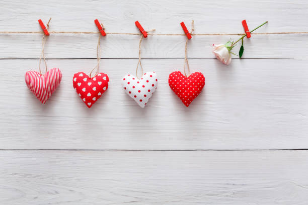 istock Valentine day background, pillow hearts border on wood, copy space 909526922