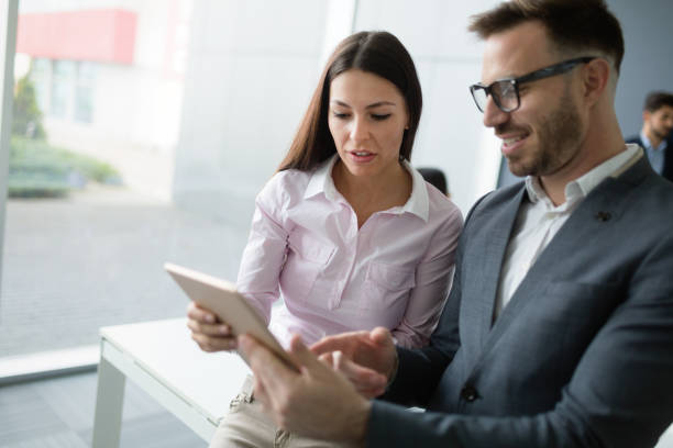 istock Happy business colleagues in modern office 909529288