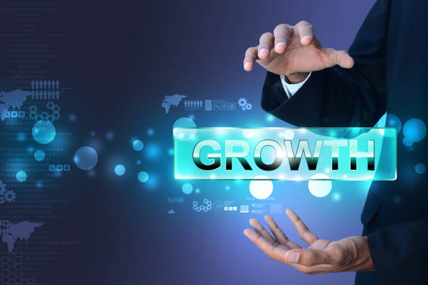 istock Businessman showing the word growth 909529424