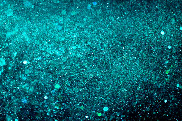 istock christmas blue gradient sparkle glitter explosion dust particles background with bokeh, color holiday happy new year and valentine day love, relationship 909533066