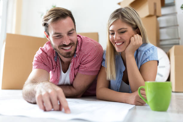 istock Young couple looking in project and planning about there new apartment 909533314