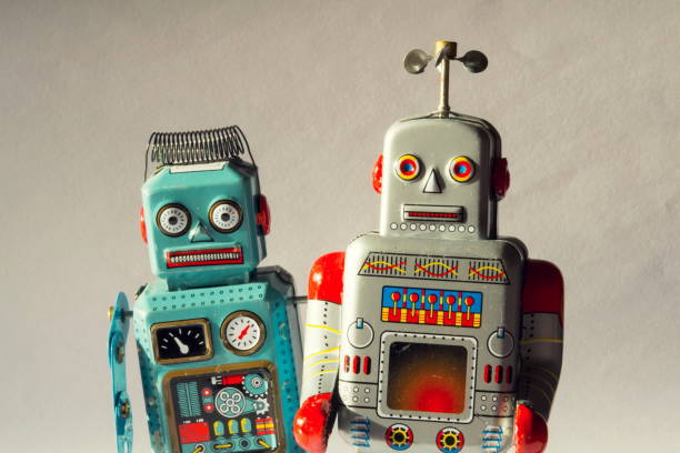 Two vintage tin toy robots, robotic delivery, artificial intelligence concept stock photo