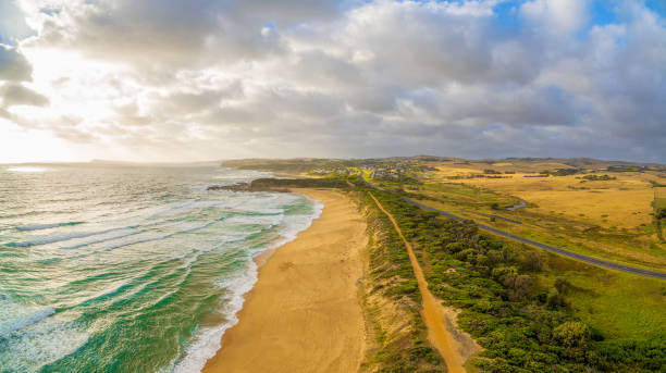 istock Glowing sunset over ocean coastline in Australia - aerial view 909533434