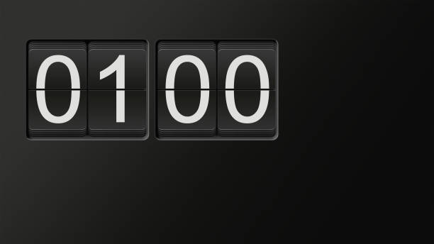 istock Classic flip clock watch face showing 01:00 with white numbers on black background 909538238